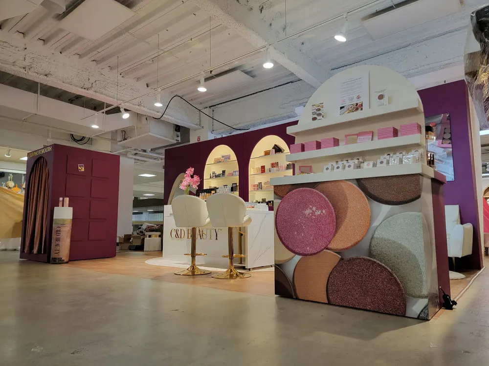 Completed custom C&D Beauty retail display with arched shelving, cabinetry, and product fixtures