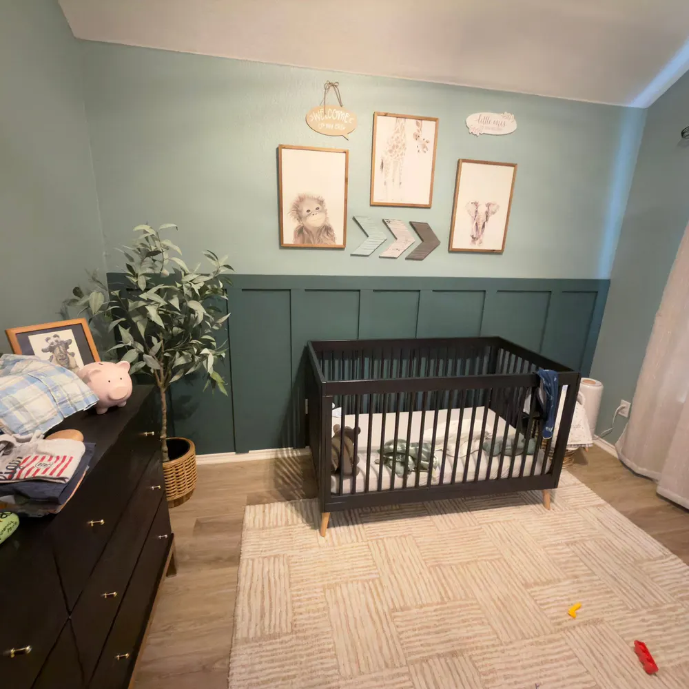 Completed green board-and-batten nursery accent wall