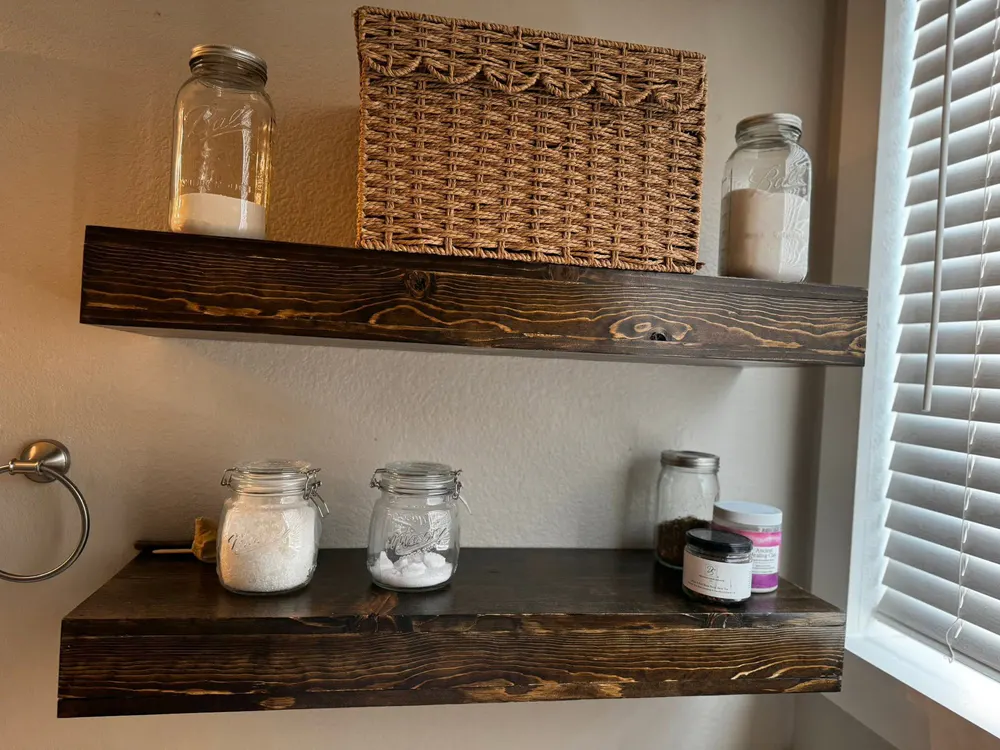 Installed dark-stained floating shelves